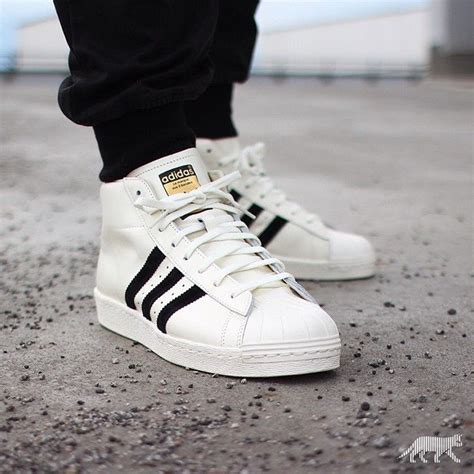 high top adidas shell toe.